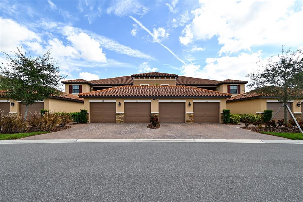 13810 Messina Loop, Unit 101 Bradenton, FL 34211 - Photo 1 of 1 a front view of a house with a yard and garage