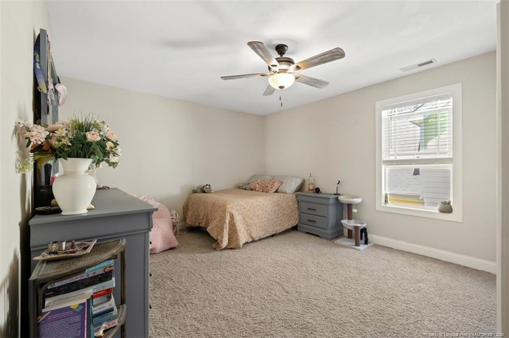 704 Micahs Way North Spring Lake, NC 28390 - Photo 27 of 43 a spacious bedroom with a bed and a window