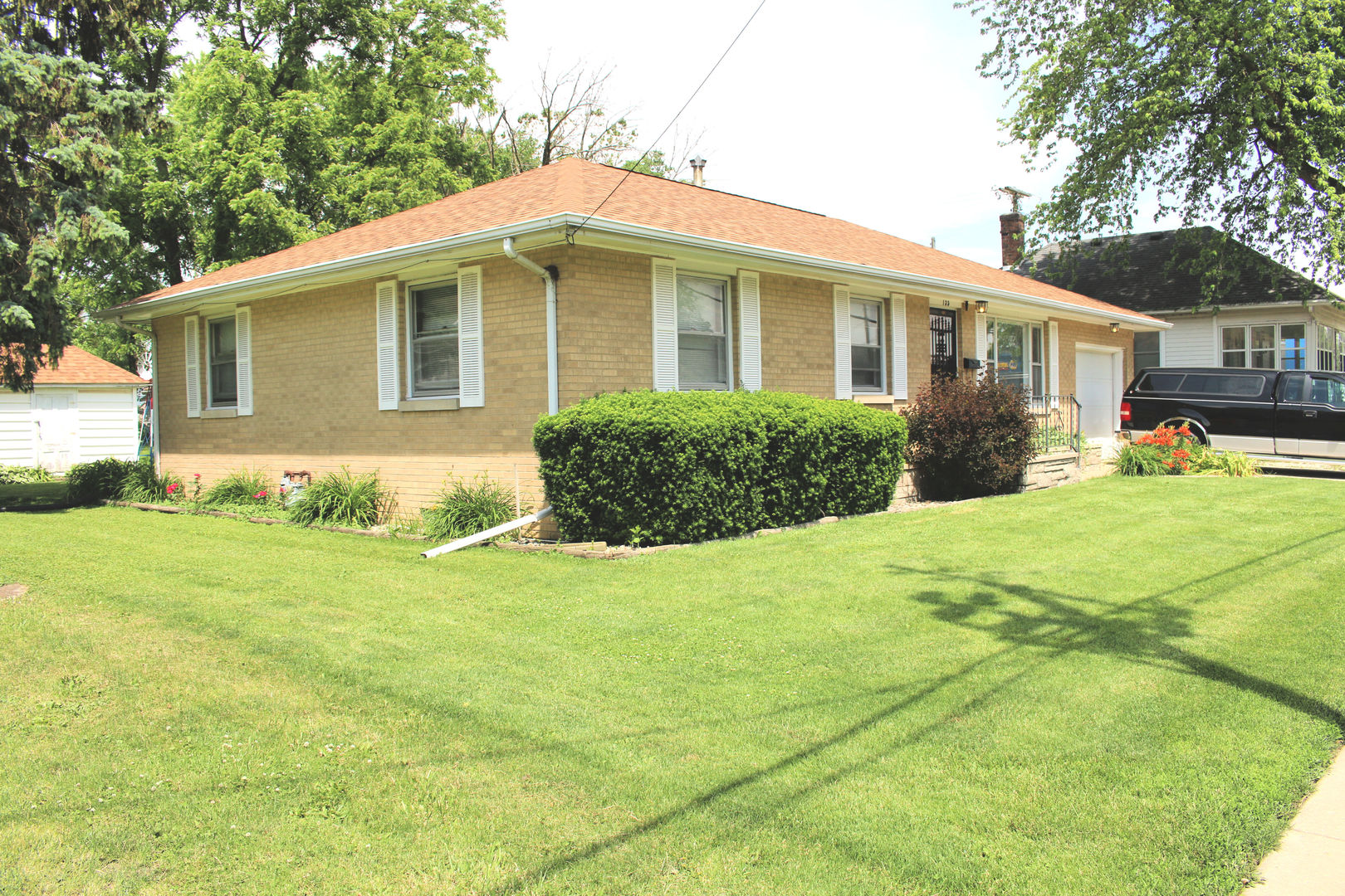 a front view of house with yard and green space
