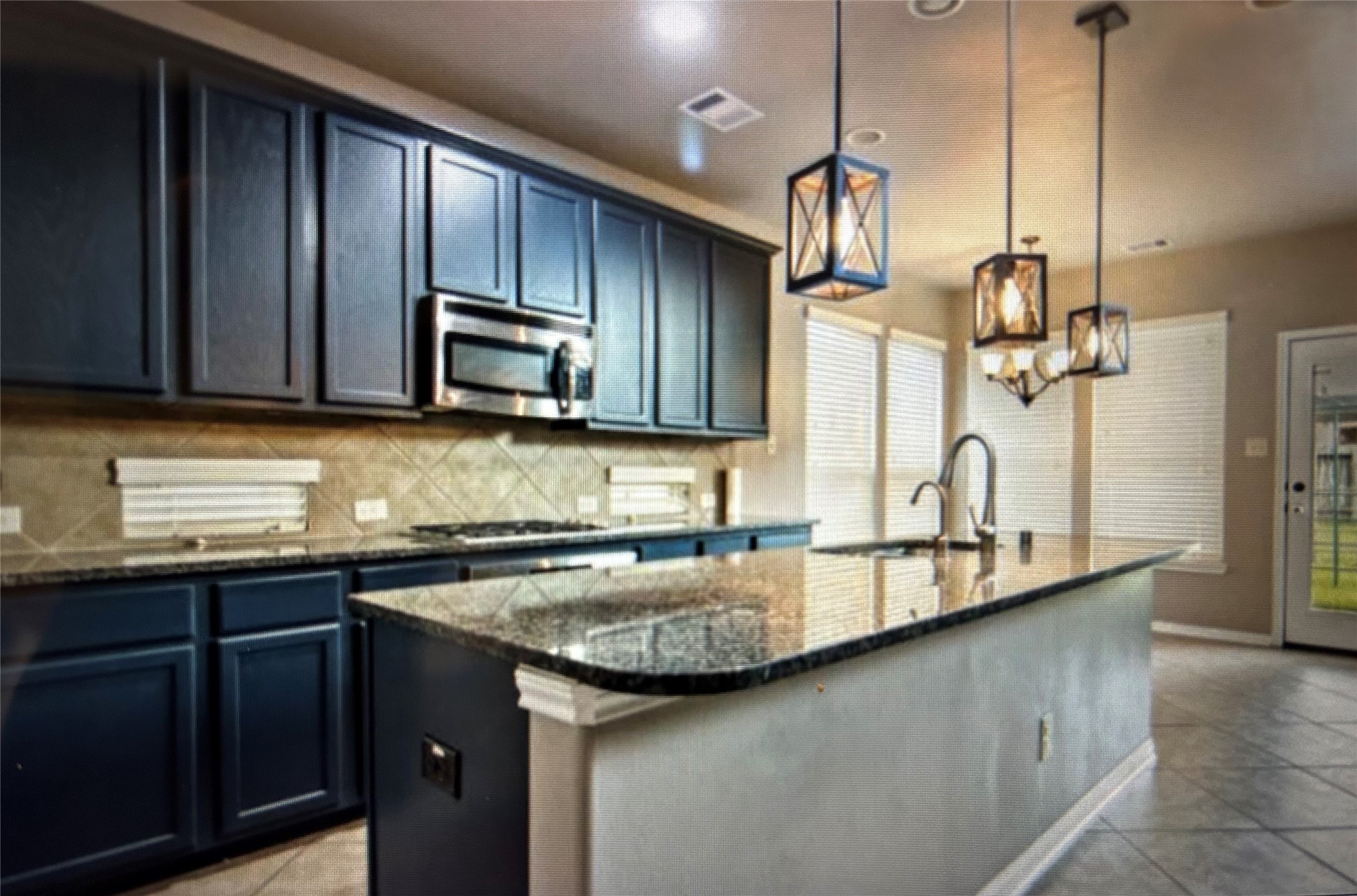 7936 Lake Commons Drive Rosenberg, TX 77469 - Photo 17 of 33 a kitchen with granite countertop a sink a stove and cabinets