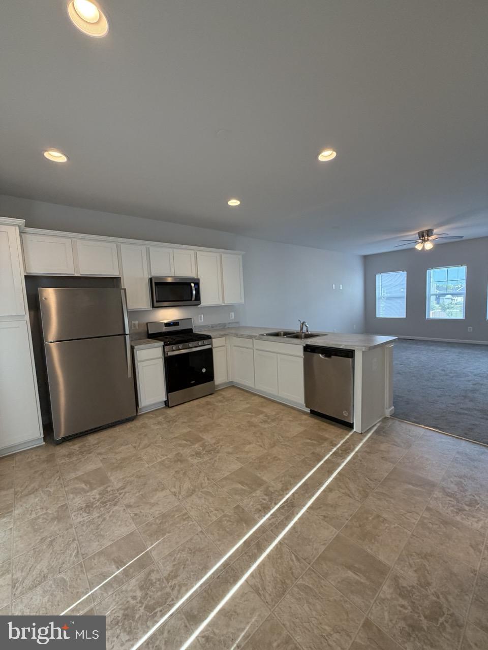 146 Galaxy Place Stephenson, VA 22656 - Photo 19 of 46 a kitchen with a refrigerator and a stove top oven
