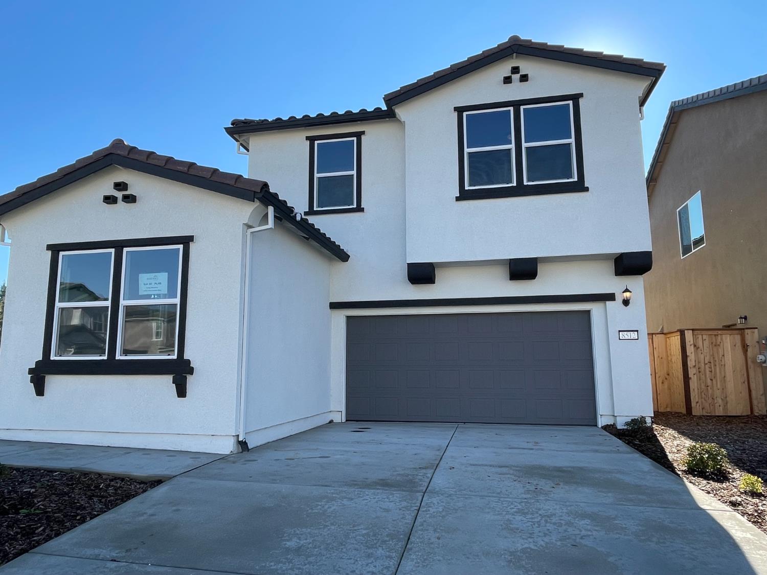 8512 Cottonseed Way Elk Grove, CA 95624 - Photo 1 of 9 a front view of a house with a garage