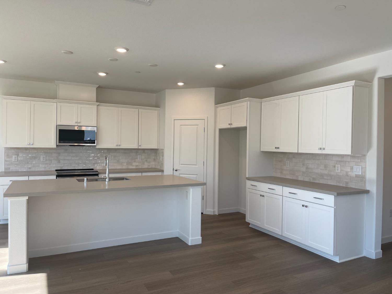 8512 Cottonseed Way Elk Grove, CA 95624 - Photo 3 of 9 a kitchen with stainless steel appliances granite countertop a stove a sink and white cabinets