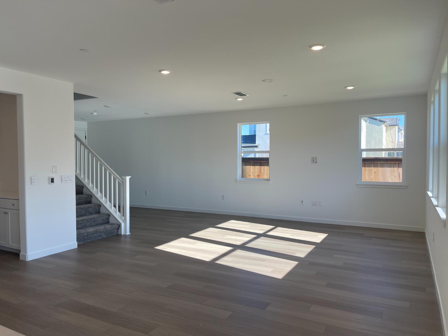8512 Cottonseed Way Elk Grove, CA 95624 - Photo 5 of 9 a view of an empty room with wooden floor and a window