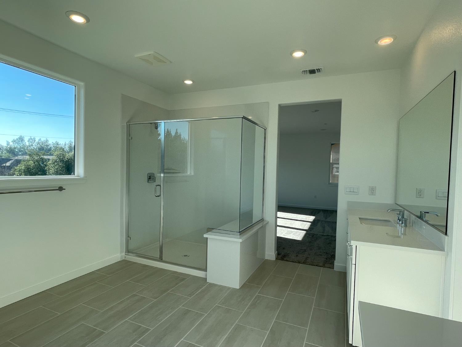 8512 Cottonseed Way Elk Grove, CA 95624 - Photo 7 of 9 a bathroom with a double vanity sink toilet and shower