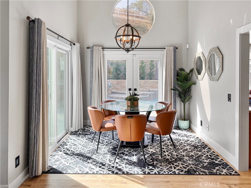 16955 Lake Knoll Parkway Riverside, CA 92503 - Photo 15 of 42 a dining room with furniture a chandelier and wooden floor