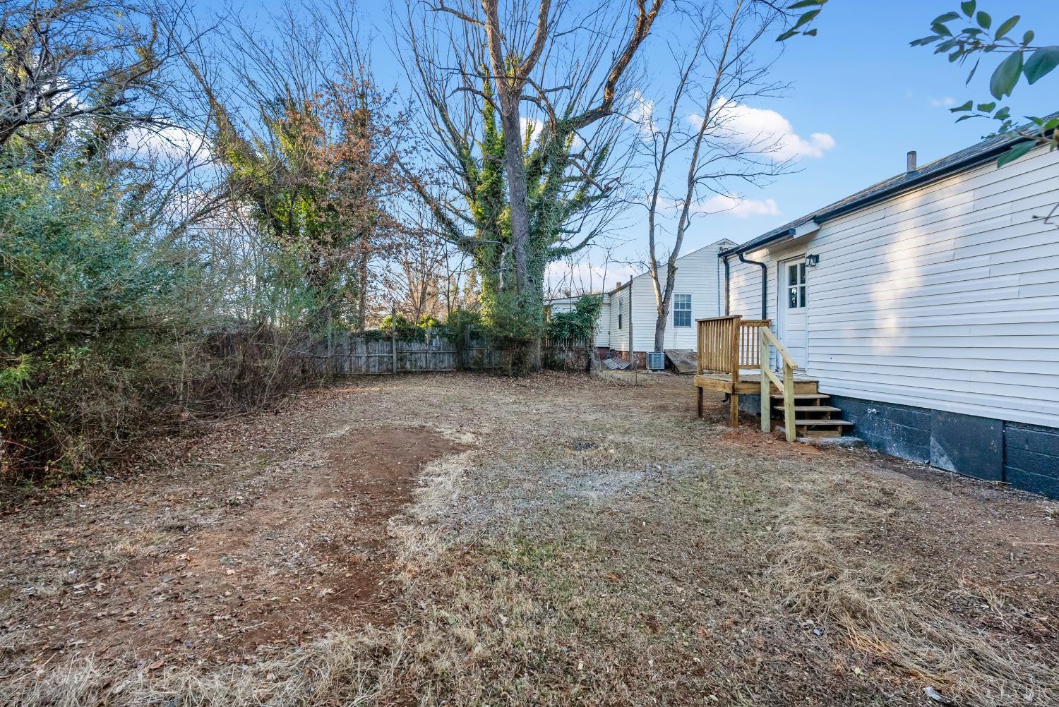 1201 Brandon Road Lynchburg, VA 24502 - Photo 21 of 25 a view of a backyard with wooden fence and large trees