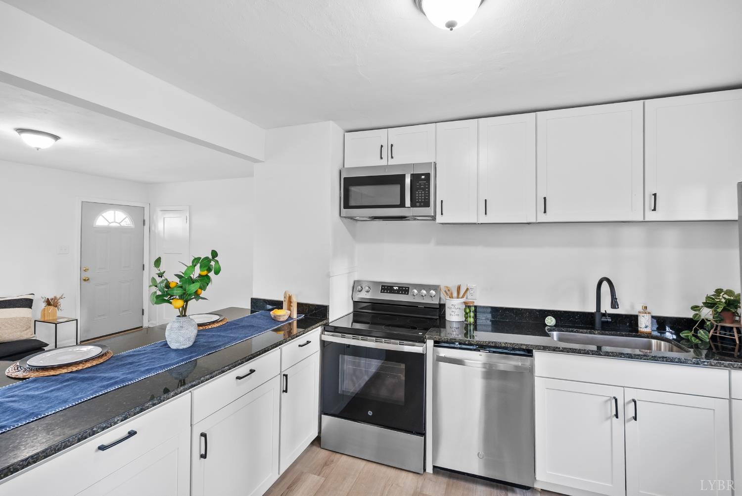 1201 Brandon Road Lynchburg, VA 24502 - Photo 6 of 25 a kitchen with a sink and white cabinets