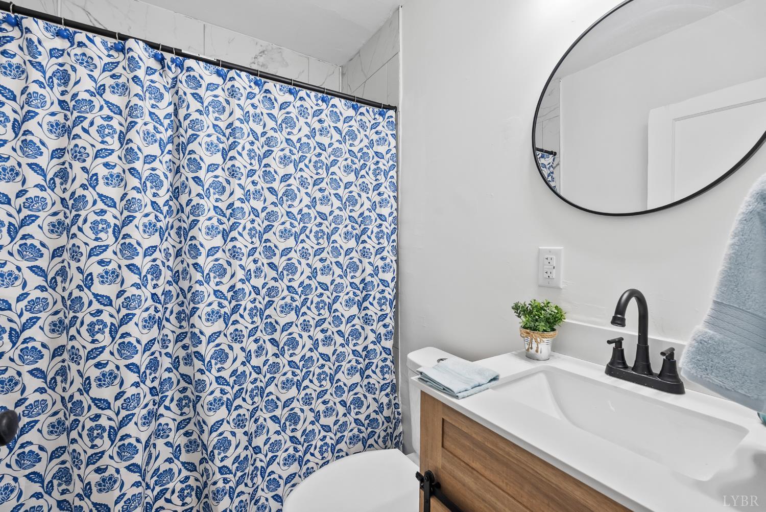 1201 Brandon Road Lynchburg, VA 24502 - Photo 8 of 25 a bathroom with a sink toilet and a mirror
