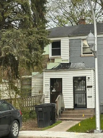 a front view of a house with parking