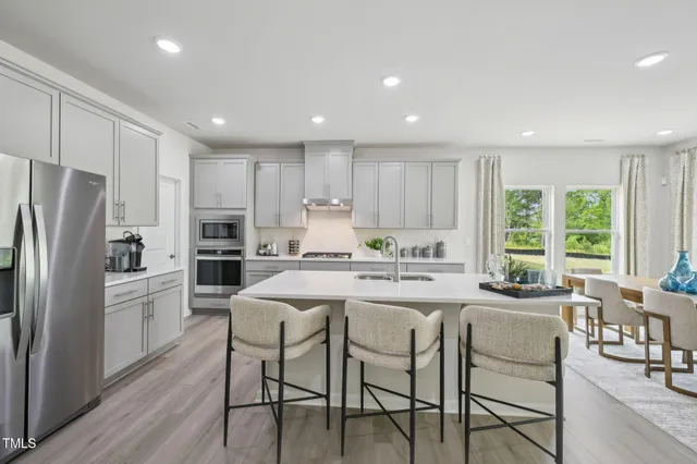 a dining room with furniture window and wooden floor