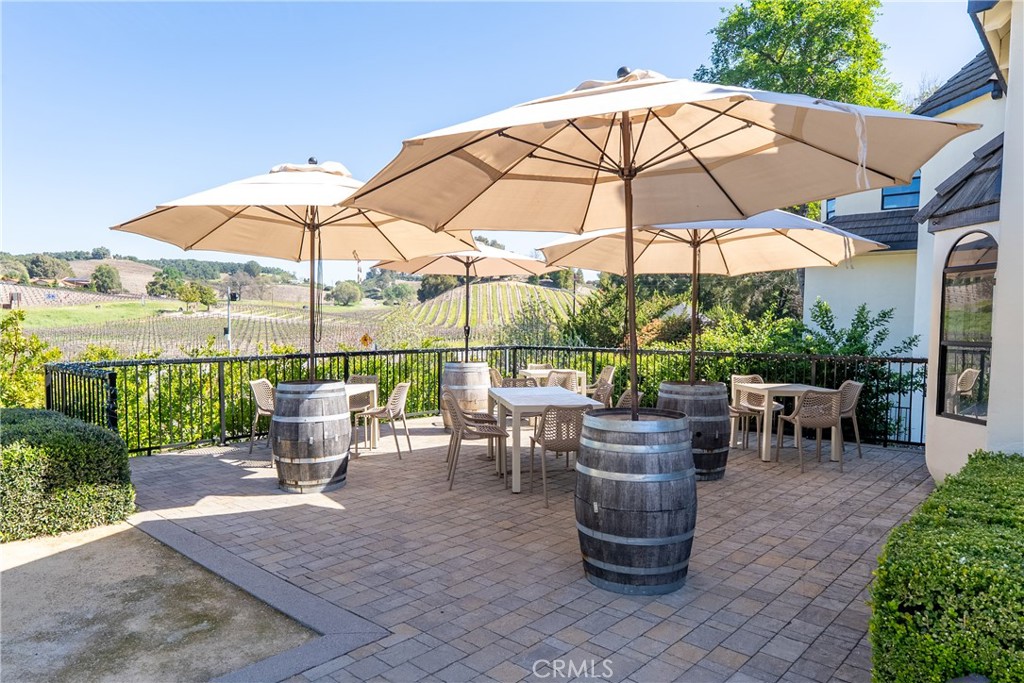 2720 Oak View Road Templeton, CA 93465 - Photo 18 of 64 a view of a tables and chairs under an umbrella