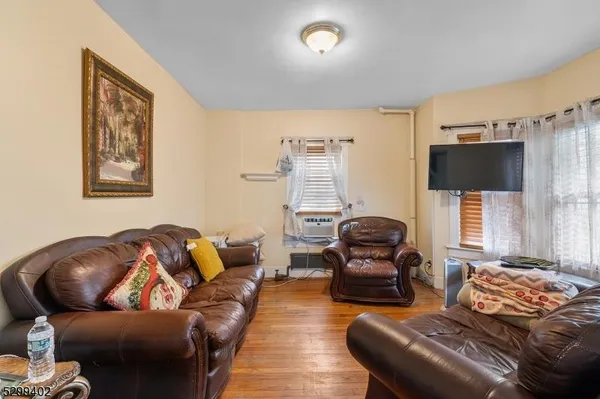 a bedroom with furniture and a flat screen tv
