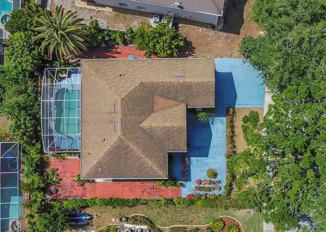 an aerial view of a house with swimming pool and garden