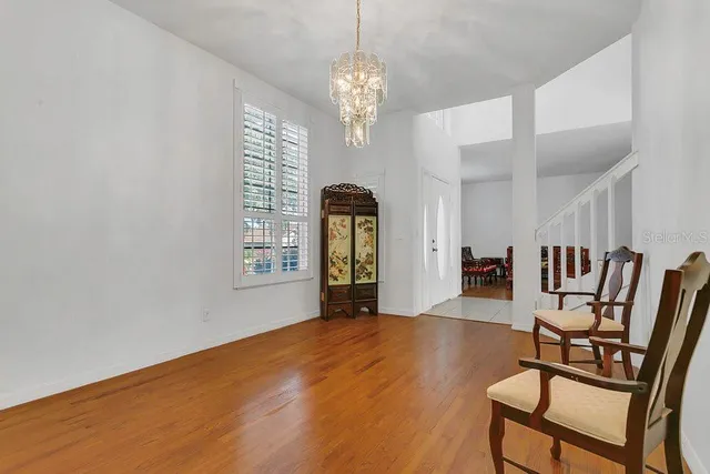 a view of a dining room with furniture and chandelier