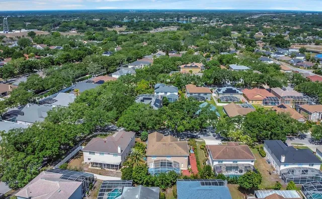 an aerial view of residential houses with city view