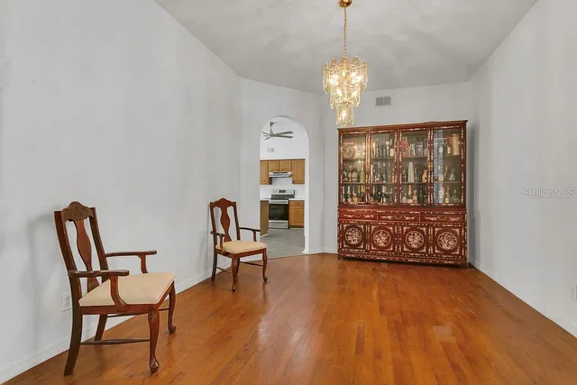 a view of a room with furniture wooden floor and front door