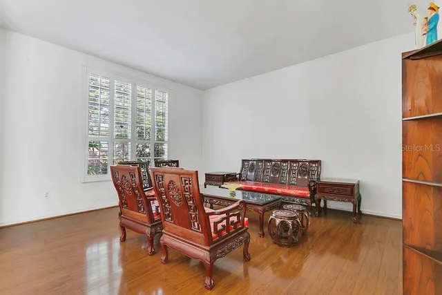 a dining room with furniture and wooden floor