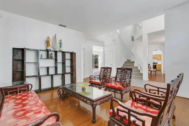 a living room with furniture a rug and a chandelier