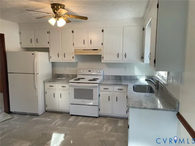 a kitchen with cabinets stainless steel appliances and a counter space