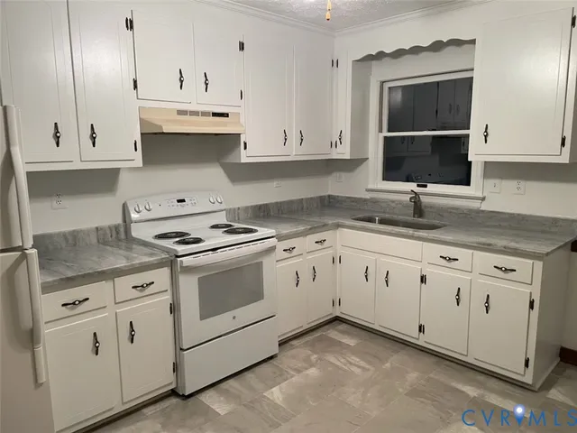 a kitchen with granite countertop white cabinets white stainless steel appliances and sink