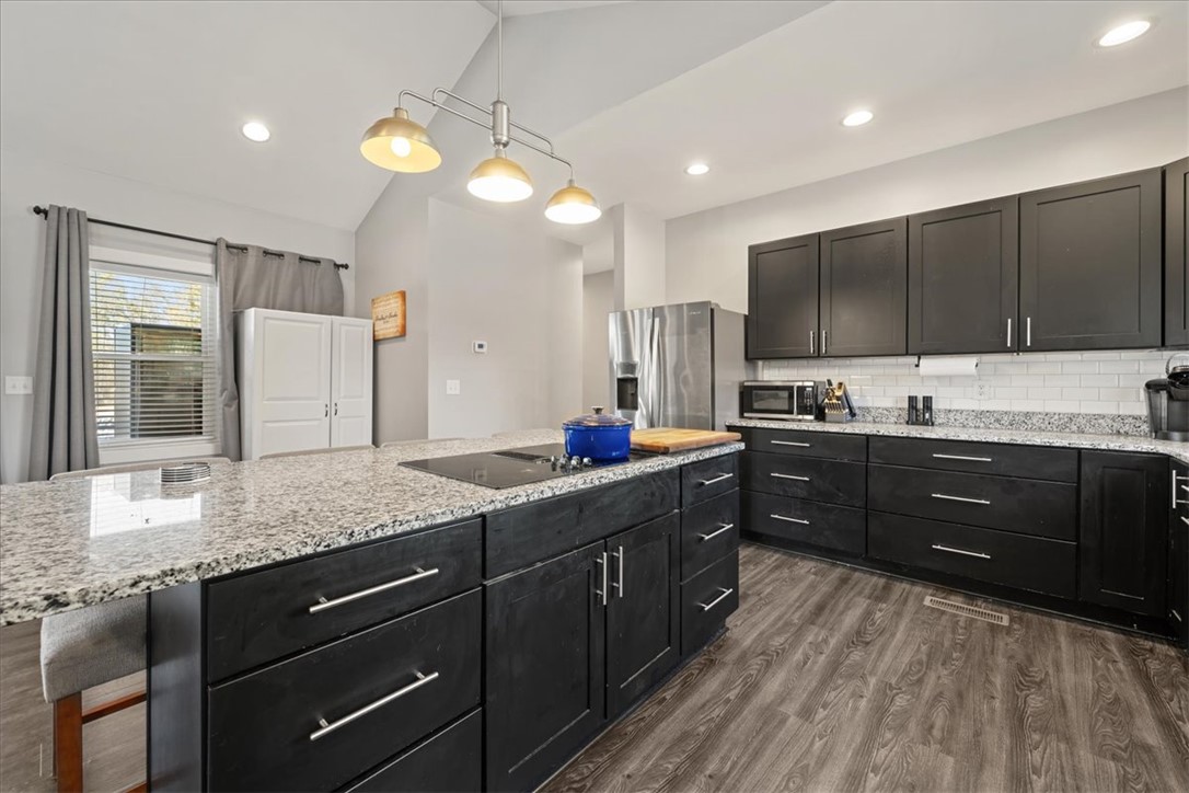 212 Winding Lane Seneca, SC 29672 - Photo 5 of 47 This contemporary kitchen features an expansive island and sleek cabinetry, perfect for culinary endeavors.