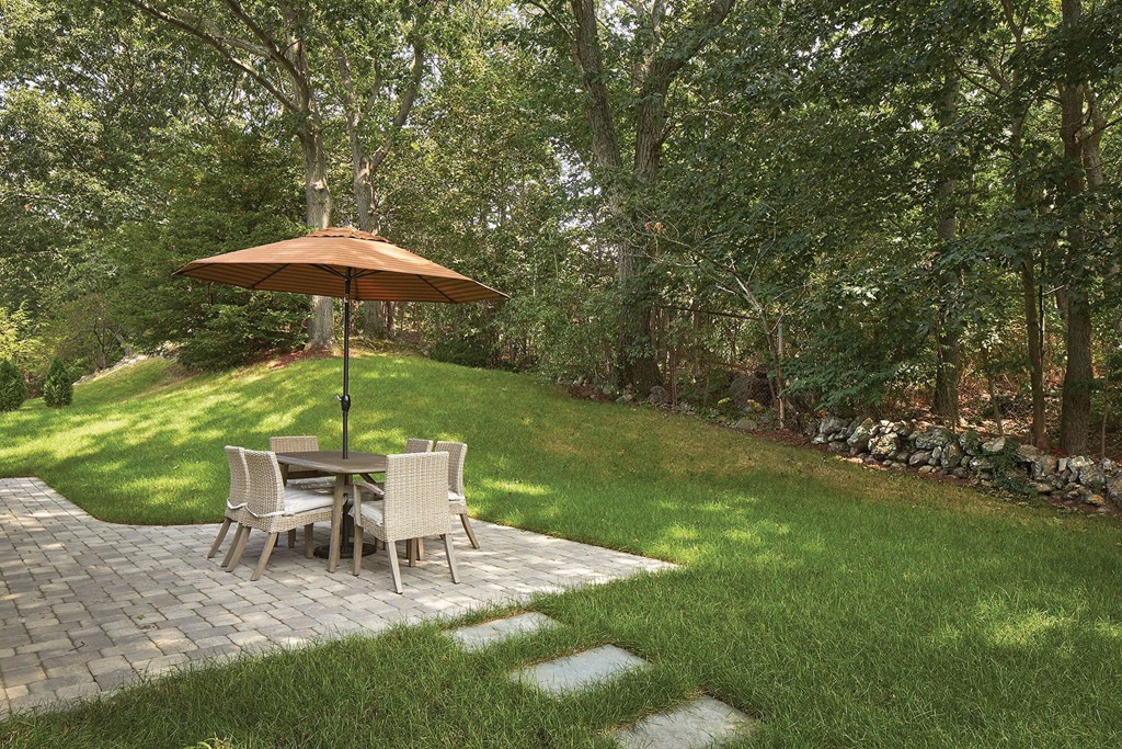 160 Bellingham Road Brookline, MA 02467 - Photo 7 of 7 a lawn chair sitting under a blue umbrella