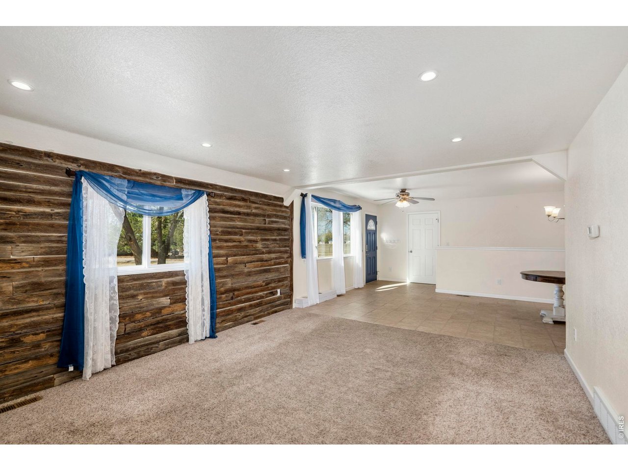 1083 2nd Street Nunn, CO 80648 - Photo 12 of 50 a view of an empty room with a fireplace and a window