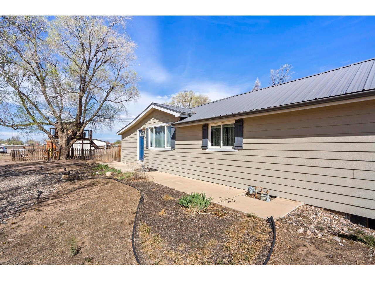 1083 2nd Street Nunn, CO 80648 - Photo 46 of 50 a view of a backyard with a large tree