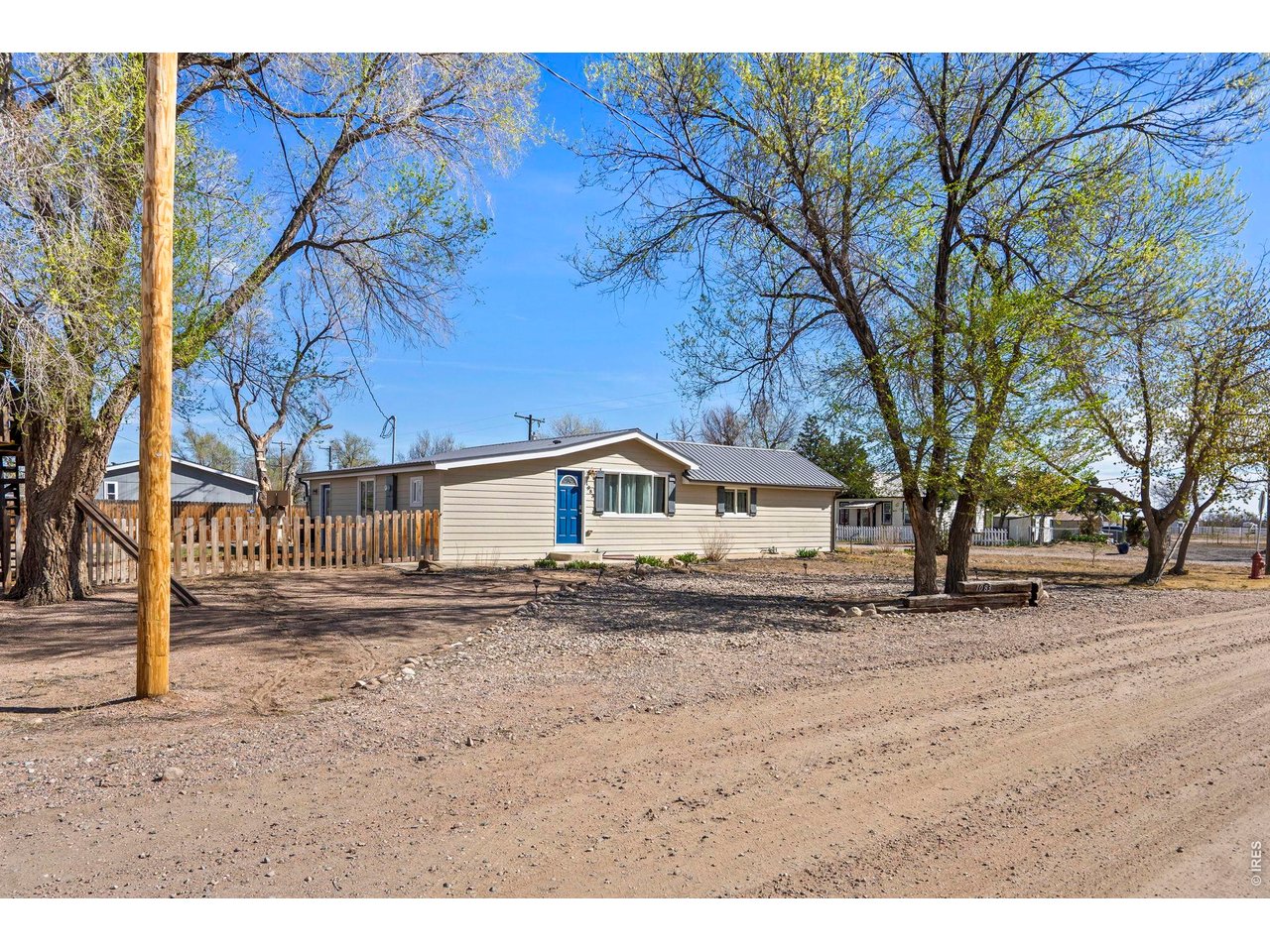 1083 2nd Street Nunn, CO 80648 - Photo 48 of 50 a white house that has a tree in front of it