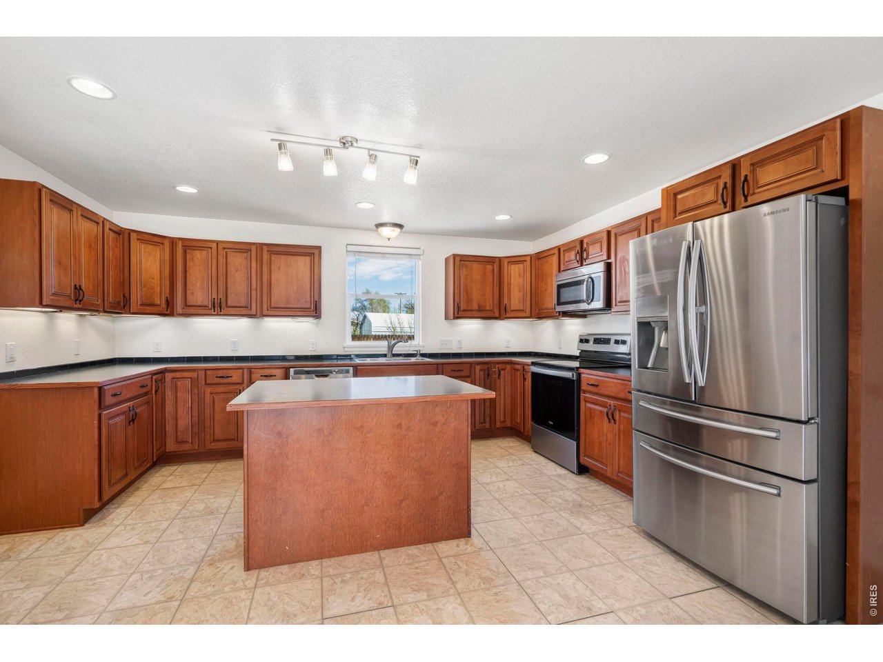 1083 2nd Street Nunn, CO 80648 - Photo 9 of 50 a kitchen with stainless steel appliances granite countertop a refrigerator a sink dishwasher a stove with large oven and wooden cabinets