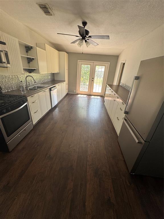 629 Harrison Lane Hurst, TX 76053 - Photo 15 of 20 a view of a kitchen with wooden floor and electronic appliances