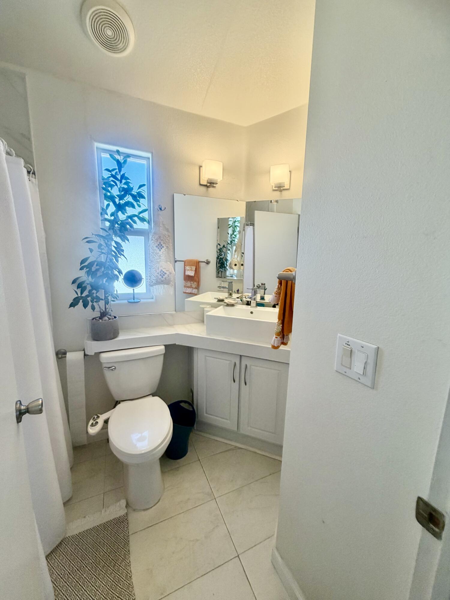 74711 Dillon Road, Unit 264 Desert Hot Springs, CA 92241 - Photo 18 of 21 a kitchen with a sink toilet and a mirror