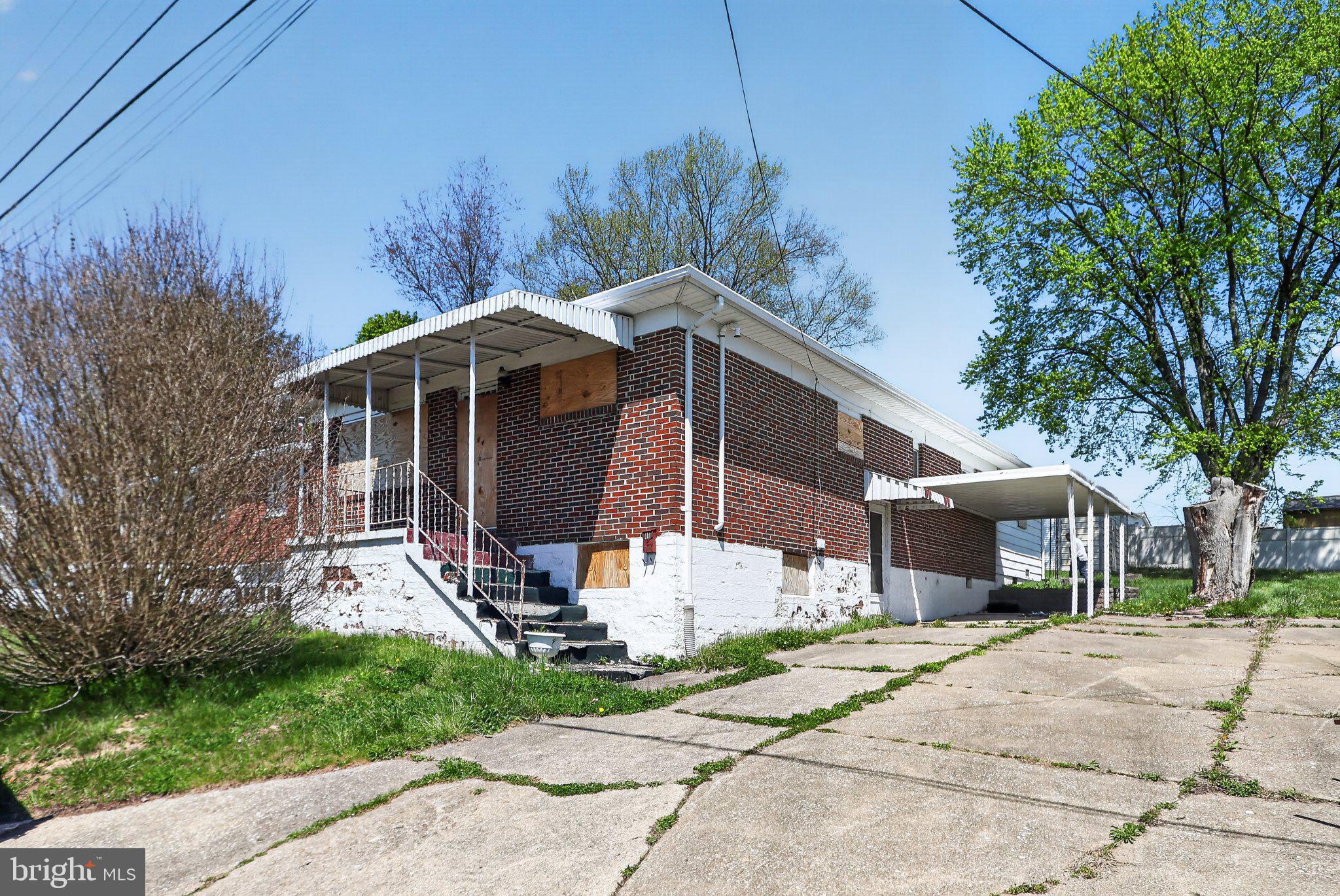 113 Cannaday Street Beckley, WV 25801 - Photo 4 of 14 a front view of a house with a garden and trees