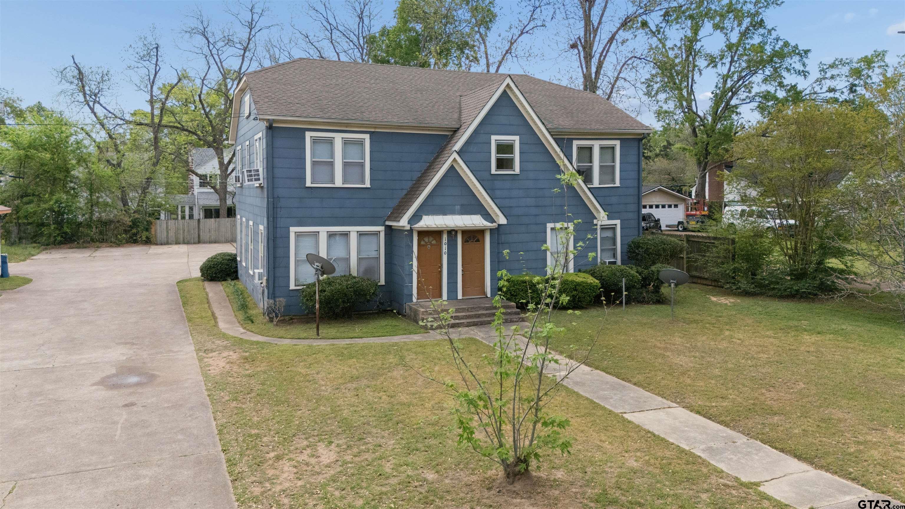 1010 Maple Street Kilgore, TX 75662 - Photo 1 of 20 a front view of a house with garden