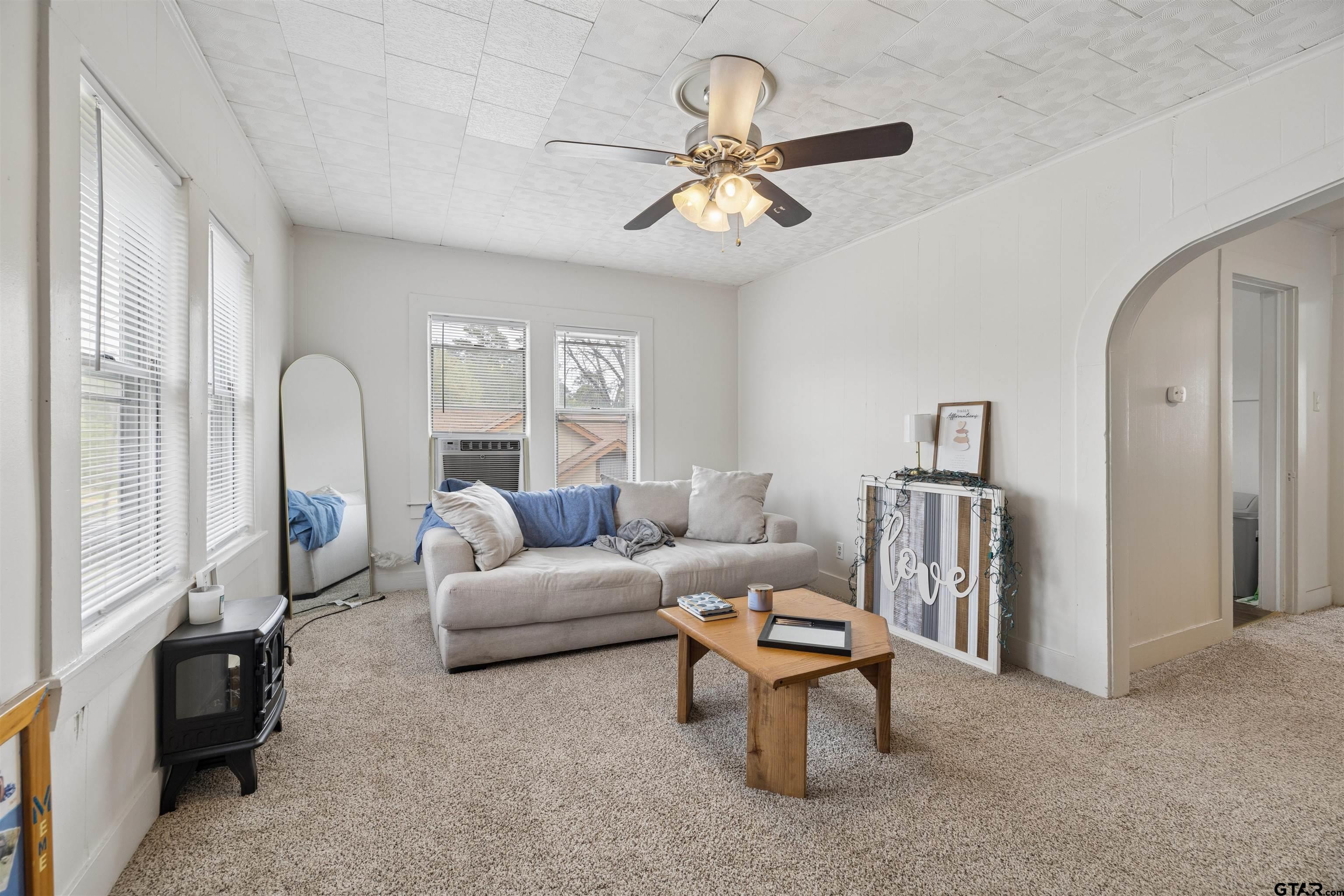 1010 Maple Street Kilgore, TX 75662 - Photo 13 of 20 a living room with furniture and a chandelier