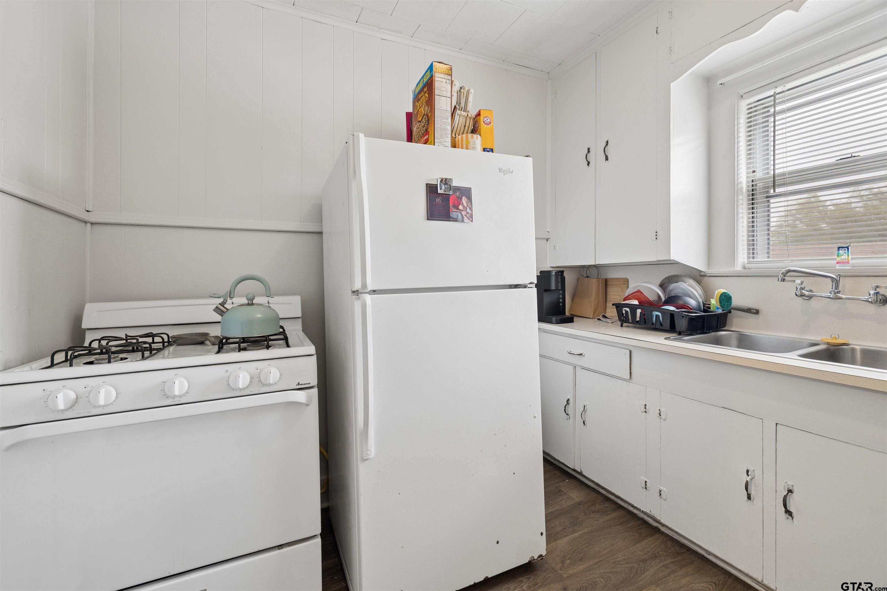 1010 Maple Street Kilgore, TX 75662 - Photo 14 of 20 a white refrigerator freezer sitting inside of a kitchen