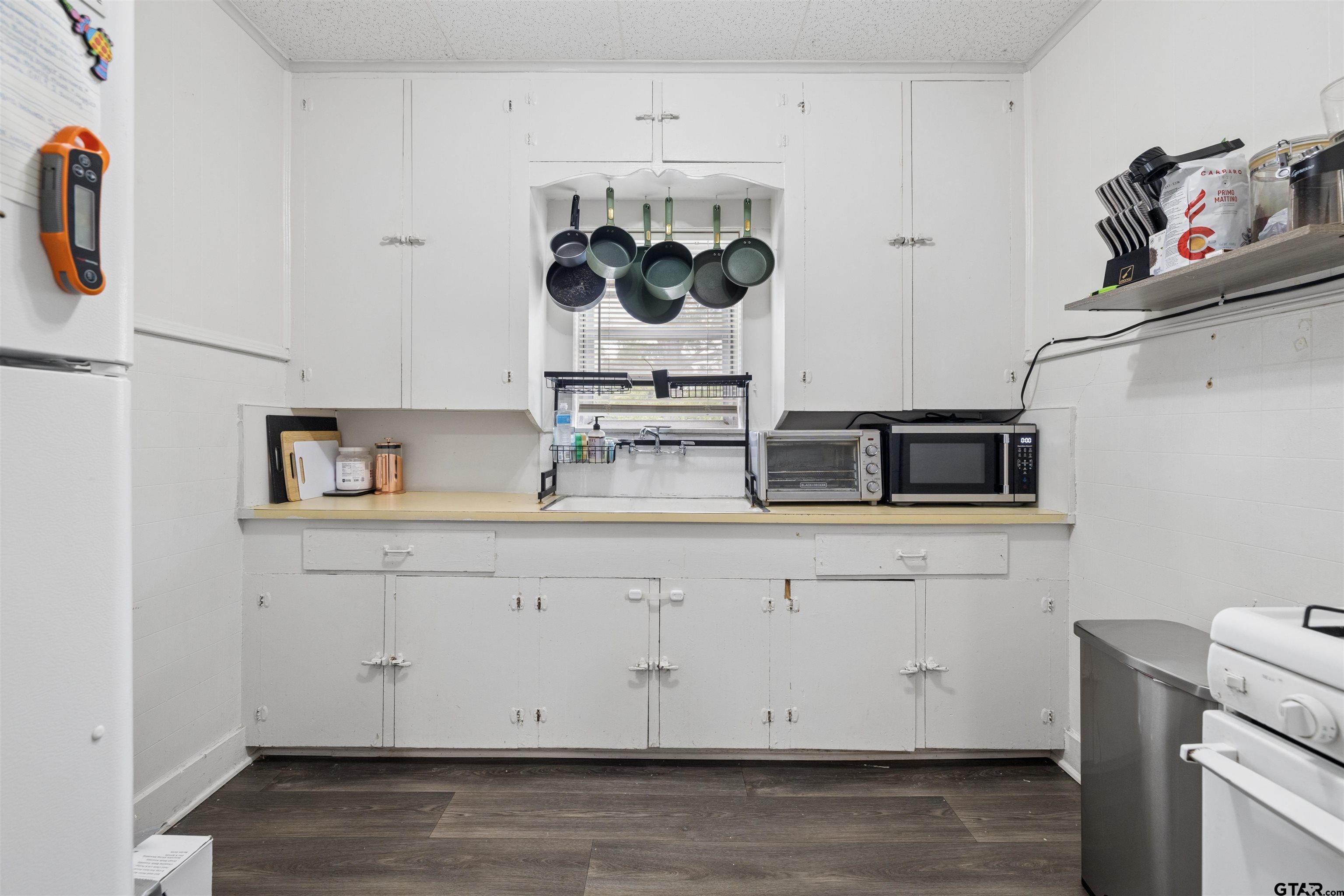 1010 Maple Street Kilgore, TX 75662 - Photo 3 of 20 a view of cabinets with wooden floor