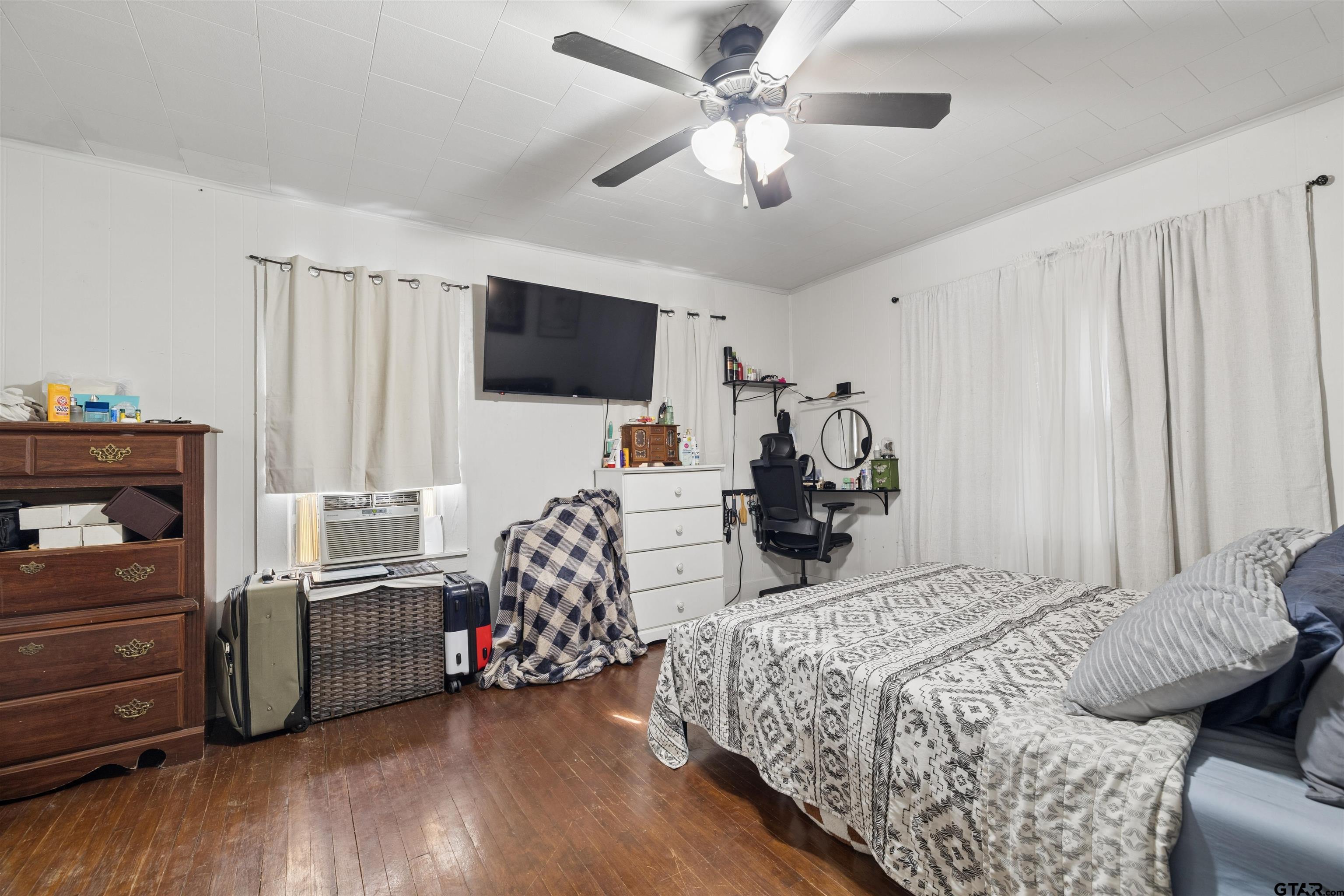 1010 Maple Street Kilgore, TX 75662 - Photo 6 of 20 a bedroom with a bed and a flat screen tv