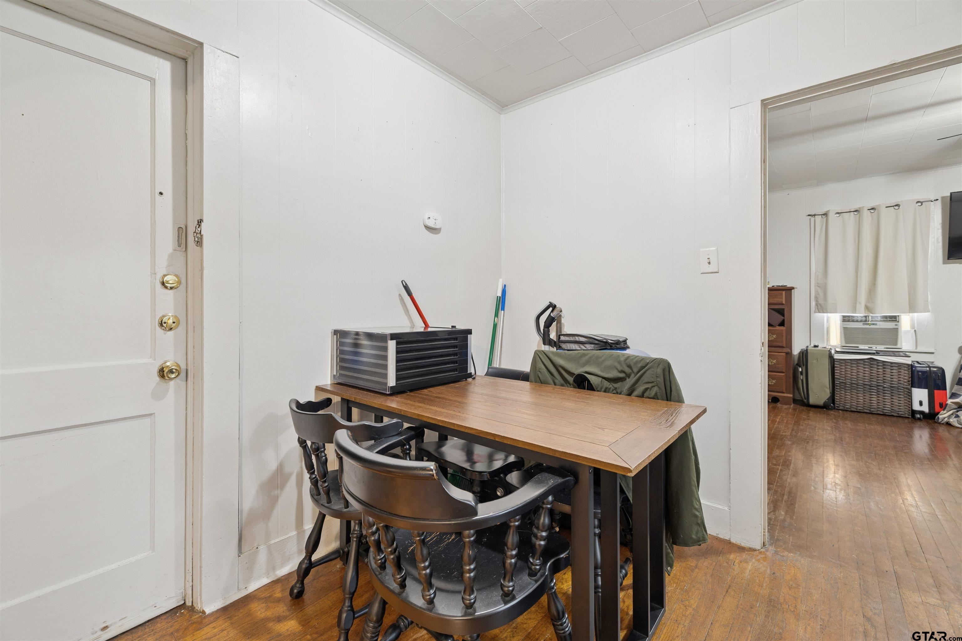 1010 Maple Street Kilgore, TX 75662 - Photo 7 of 20 a view of a dining room with furniture and wooden floor