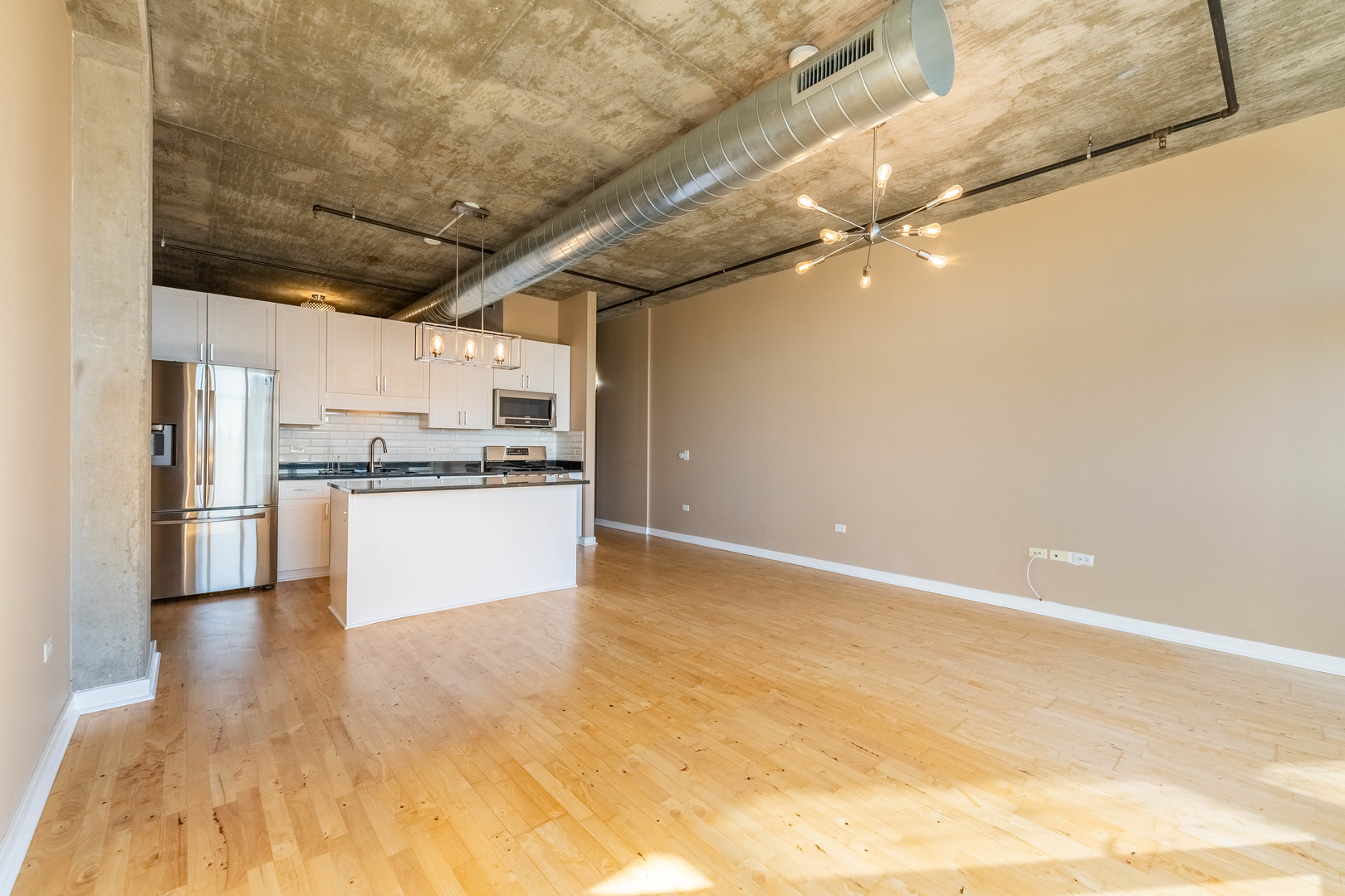 50 East 16th Street, Unit 411 Chicago, IL 60616 - Photo 6 of 22 a view of kitchen refrigerator and microwave