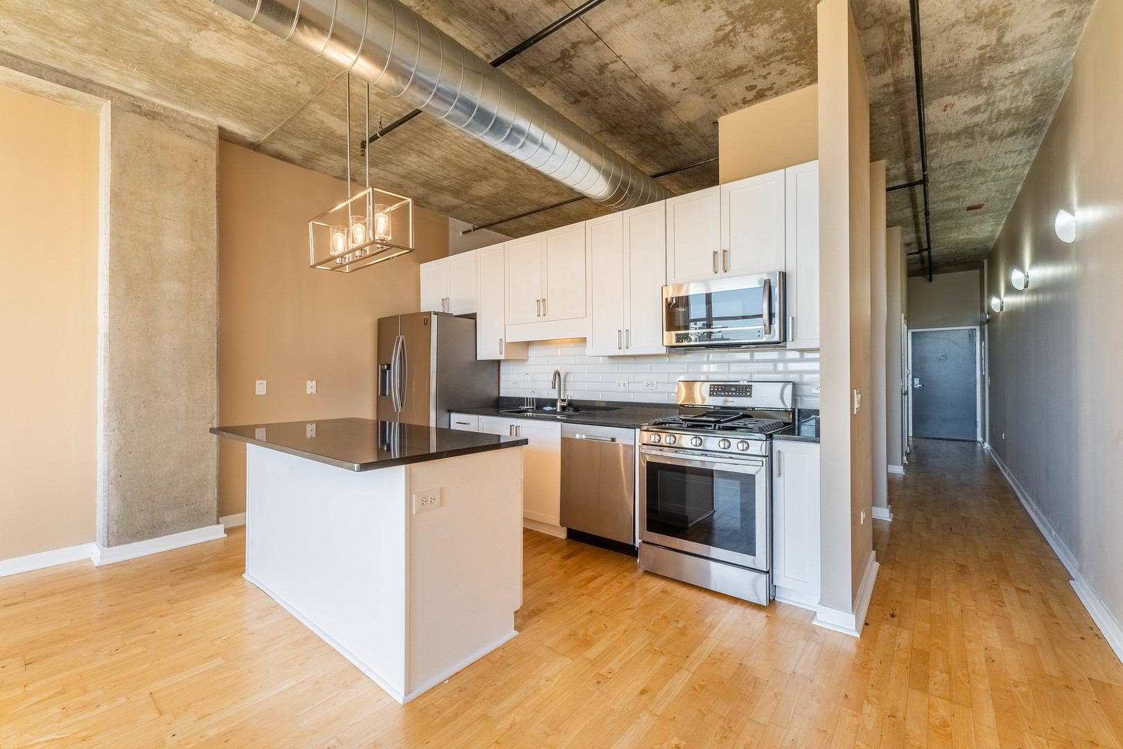 50 East 16th Street, Unit 411 Chicago, IL 60616 - Photo 10 of 22 a kitchen with stainless steel appliances a stove a sink and a refrigerator