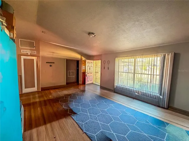 a kitchen view with wooden cabinets and entryway