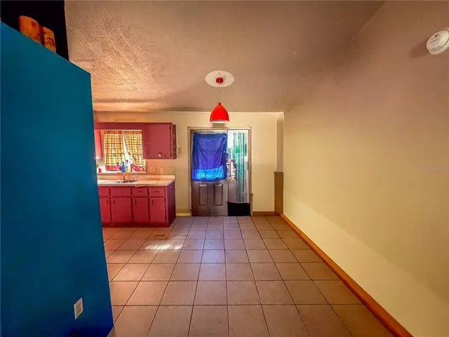 a kitchen with stainless steel appliances granite countertop a refrigerator a sink dishwasher a stove with wooden cabinets