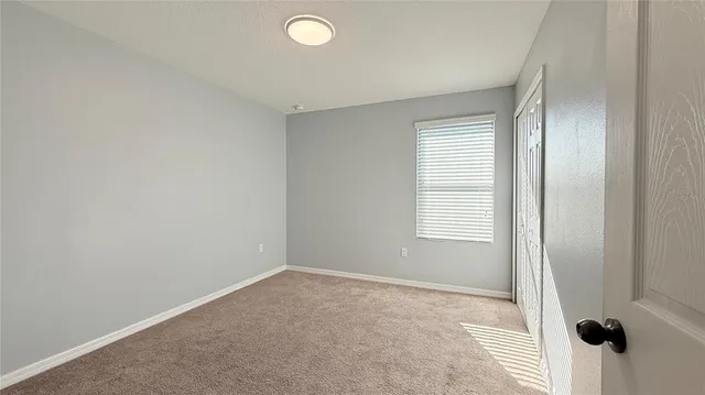 a view of a hallway with an entryway and closet