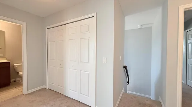 an empty room with fan and windows