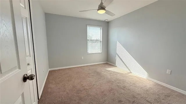 a view of a hallway with an entryway door