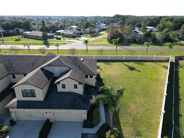 an aerial view of residential houses with outdoor space and river