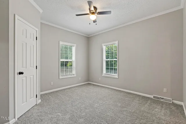 a view of a room with a window and a ceiling fan