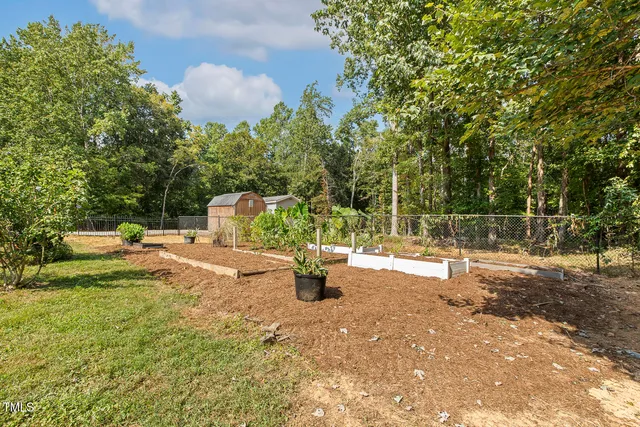 a backyard of a house with table and chairs